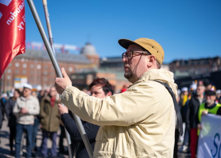 Paavo Arhinmäki kantoi vasemmistoliiton lippua vappuna 2023.